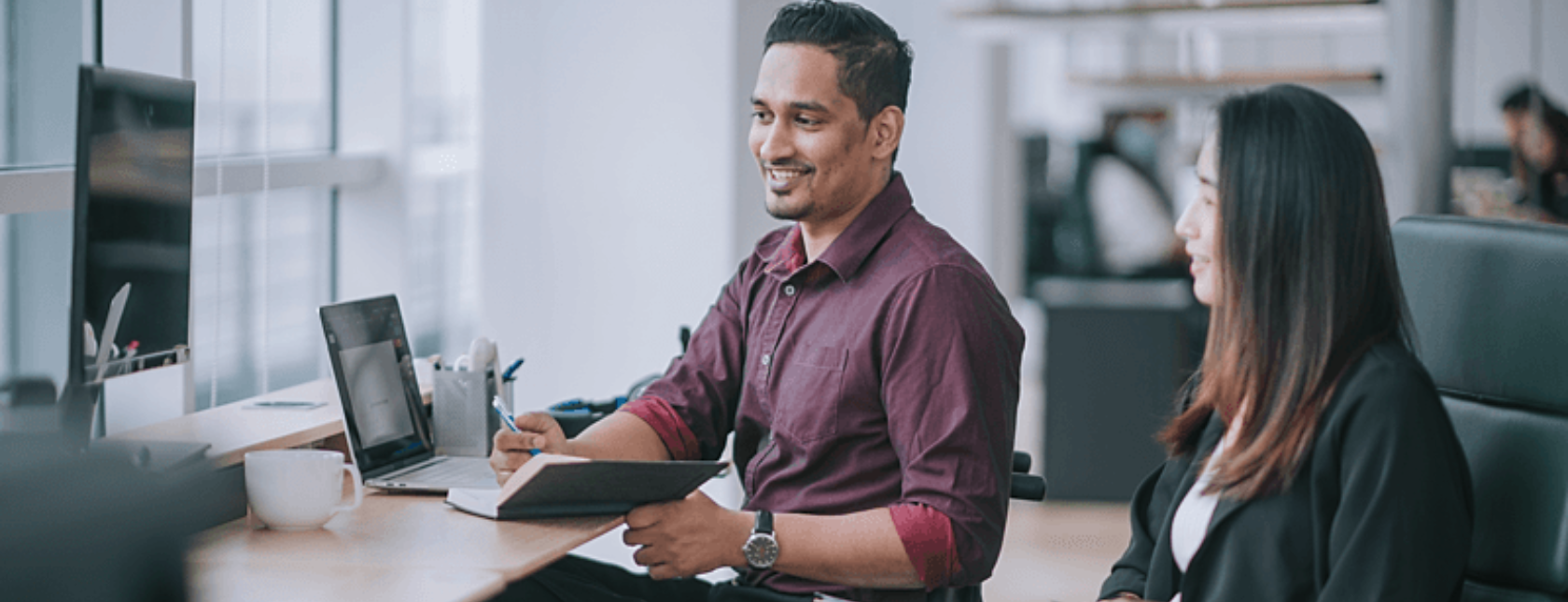 Employee in having a conversation with his female colleage