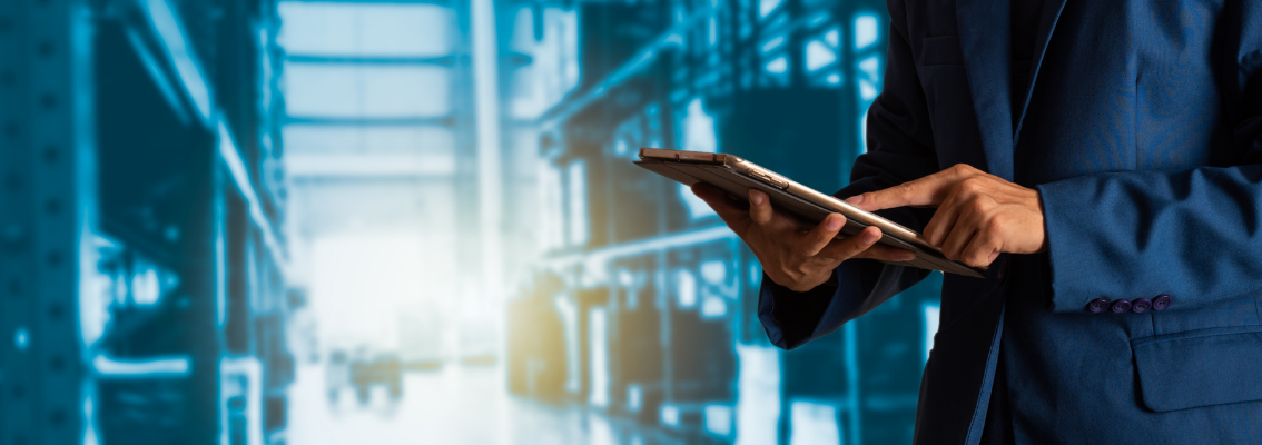 uno in completo con iPad nel magazzino